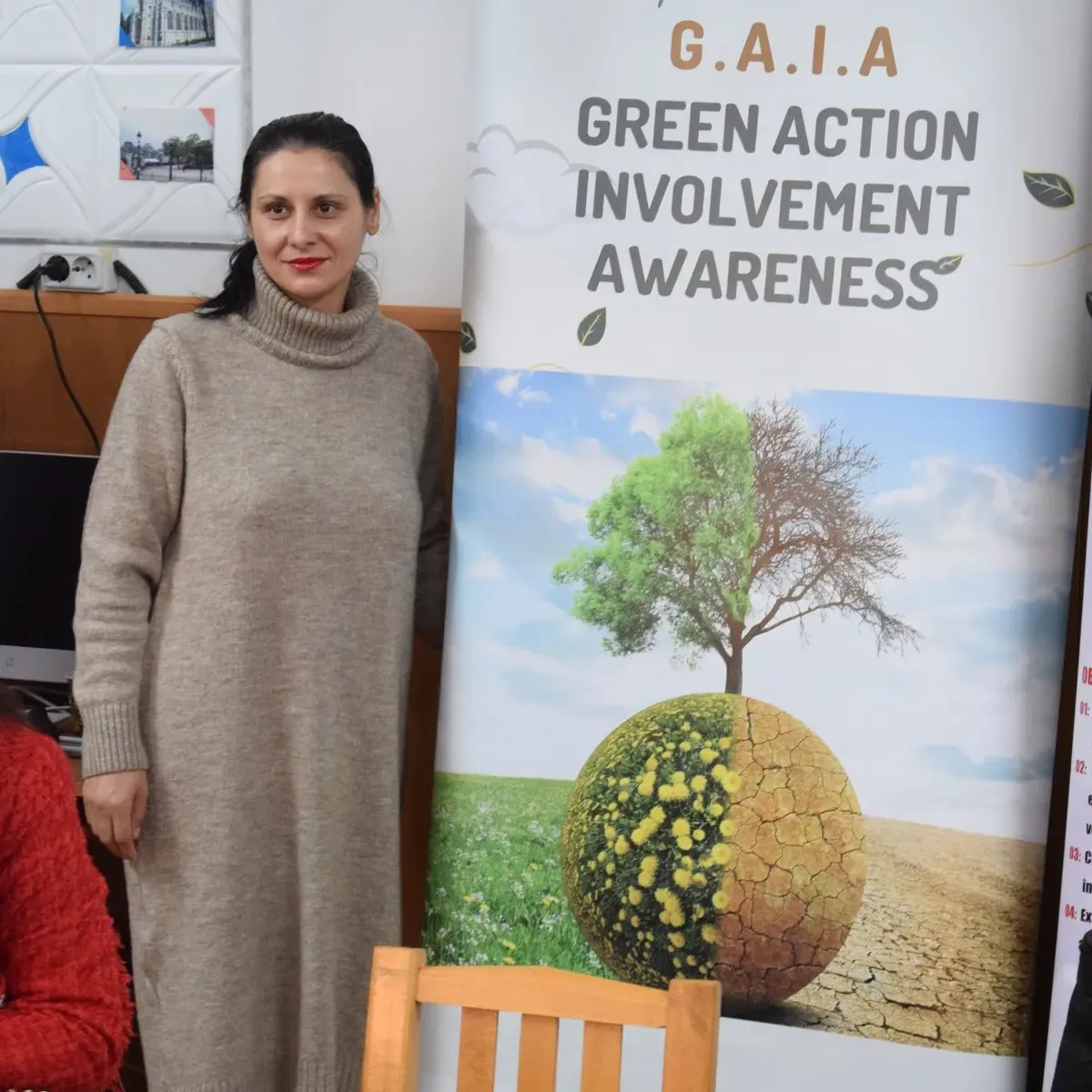Project team member next to the GAIA - Green Action Involvement Awareness roll-up banner