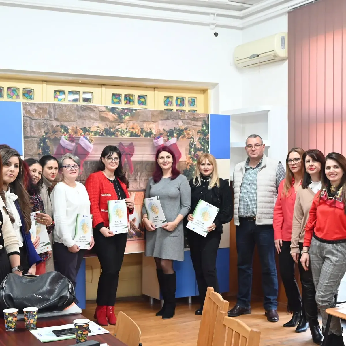 Group of teachers holding GAIA folders at the end of the event