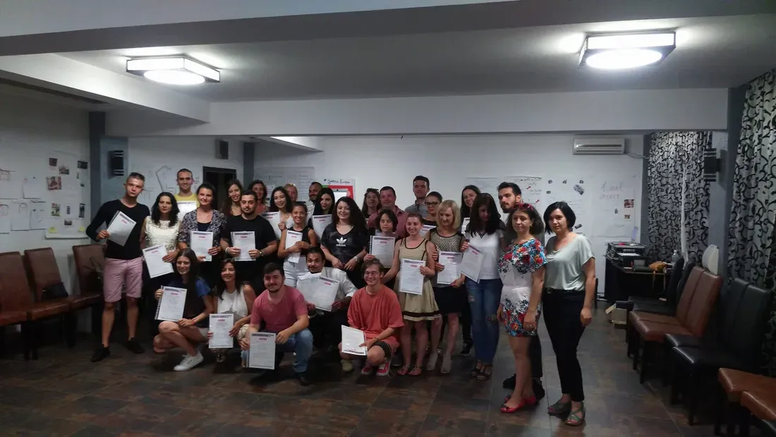 The whole group holding their certificates at the end of the training